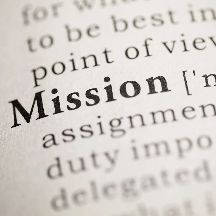 Close-up of the word mission in a dictionary symbolizing church purpose.